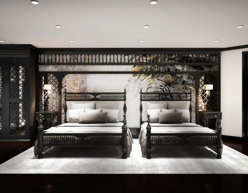 two beds in a bedroom with black and white at Era Cruises Halong in Ha Long