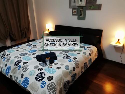 a bedroom with a bed with a sign on it at De Rossi Holiday 'Rooms&Apartment' in Bari