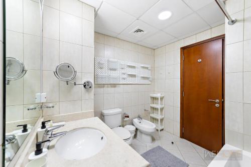 a bathroom with a sink and a toilet at WelHome - Serene Bliss: Regent House 2 Studio Haven in Dubai
