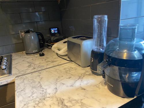 a kitchen counter with a blender and a toaster at A modern flat in Southeast London in London