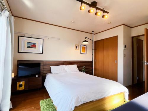 Llit o llits en una habitació de Shimokitazawa Akima