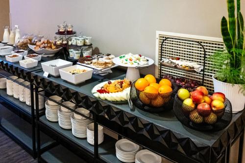 a buffet with fruits and other foods in baskets at VICTORIA Hotel Kaunas in Kaunas