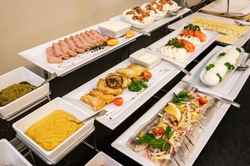 a buffet line with many different types of food at VICTORIA Hotel Kaunas in Kaunas