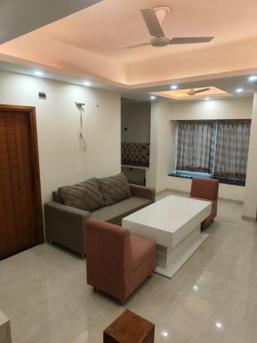 a living room with a couch and a table at Villa in Vrindavan, Hare Krishna M (ISKCON) campus in Vrindāvan
