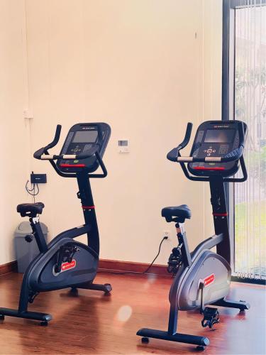 a gym with three exercise bikes in a room at Vinholidays Fiesta Phu Quoc in Phu Quoc