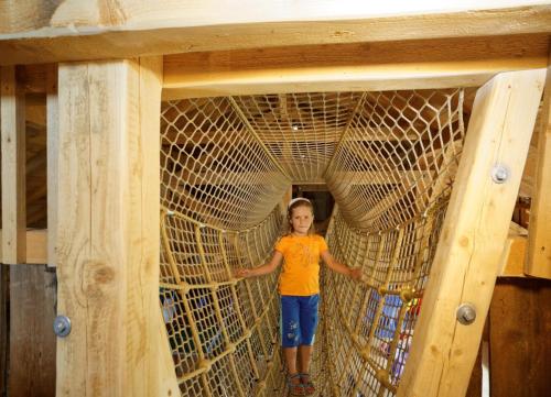 a young girl standing inside of a large net at Erlebnishof Reiner - Urlaub auf dem Bauernhof in Sankt Englmar