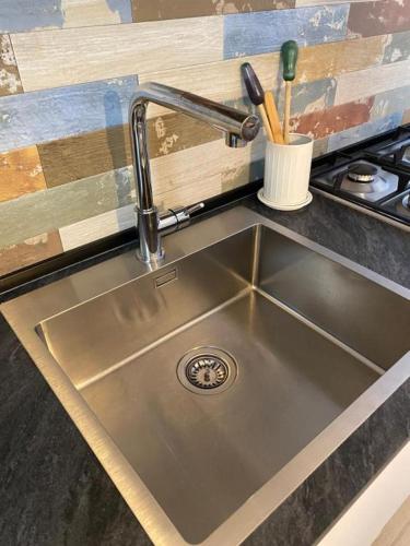 a stainless steel sink in a kitchen next to a stove at Casa Marì in Sulzano