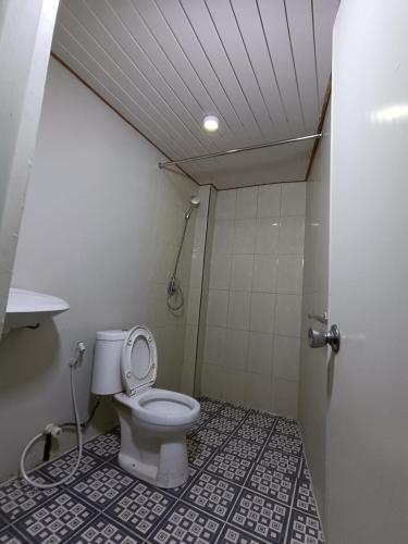 a bathroom with a toilet and a shower at Jogja Amor Hotel in Demangan