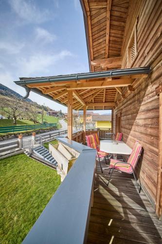 a patio with a table and chairs on a deck at Miller Appartements in Sankt Veit im Pongau