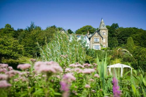 a house in the middle of a field of flowers at Yewfield Self Catering Apartments in Hawkshead
