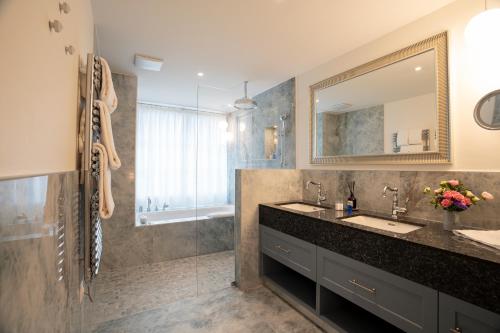 a bathroom with a sink and a mirror at Mirabeau Etoile in Zermatt