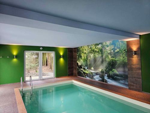 a swimming pool in a house with a large window at Holiday home in Coswig 3105 in Möllensdorf
