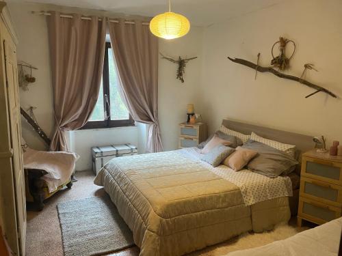 a bedroom with a bed in a room with windows at Casa della Nonna in Porretta Terme