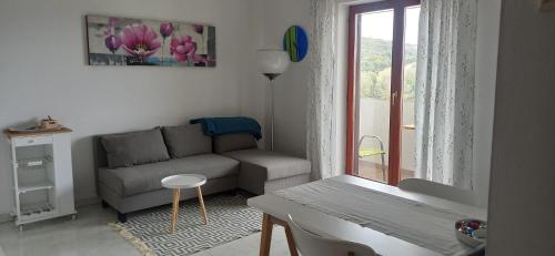 a living room with a couch and a window at Apartment Iva in Pula