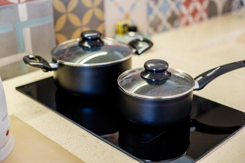 two pots sitting on top of a stove at Il Pumo Bianco Ostuni Suite in Ostuni