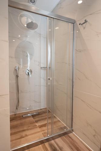 a shower with a glass door in a bathroom at Volos Inn Hotel in Volos