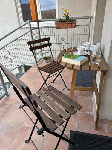 a wooden table and a chair on a balcony at Schön möblierte Wohnung in Genthin/ OT Tucheim in Tucheim