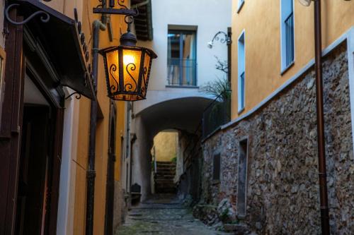 an alley with a street light next to some buildings at The Lake House by Quokka 360 - Lake view in Gandria village in Lugano