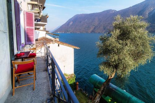 a balcony with a view of a body of water at The Lake House by Quokka 360 - Lake view in Gandria village in Lugano