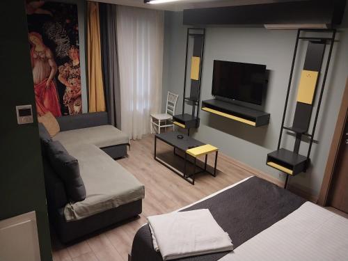 a room with two beds and a flat screen tv at BUTİK 24 SUİTES in Ankara