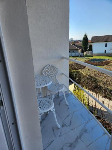 two chairs and a table on a balcony at Vila Reghina in Alba Iulia