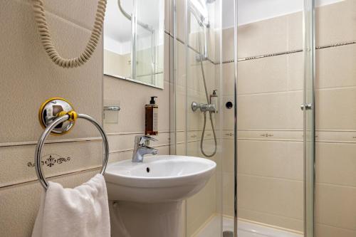 a bathroom with a sink and a shower at Hotel Victoria in Piteşti