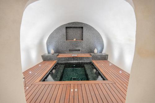 an indoor hot tub in a room with a wooden deck at Beau Clocher in Saint-Tropez