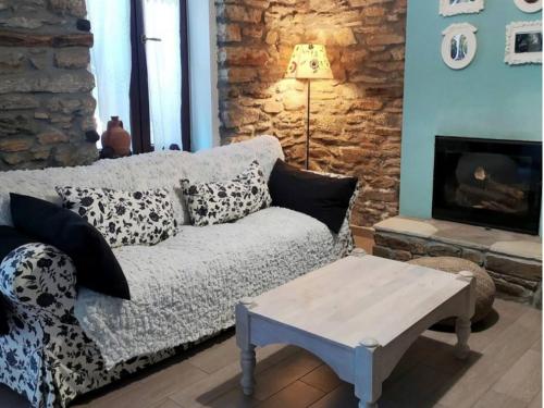 a living room with a couch and a fireplace at Beautiful cottage in Zagora in Zagora