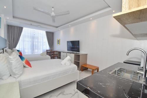 a hotel room with a bed and a sink at Bale Mi Boracay in Boracay