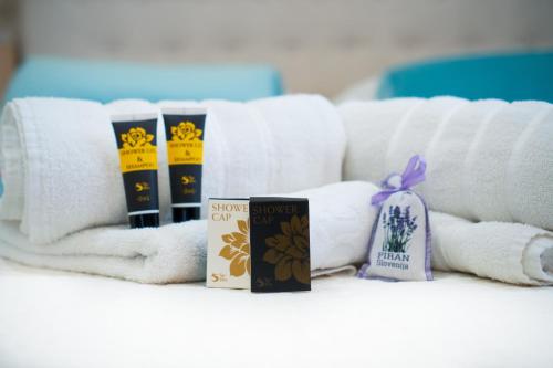 a pile of towels and books on a table at Amarru Apartments in Piran