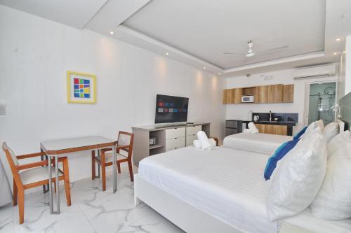 a hotel room with two beds and a table at Bale Mi Boracay in Boracay