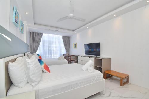 a hotel room with a bed and a desk at Bale Mi Boracay in Boracay