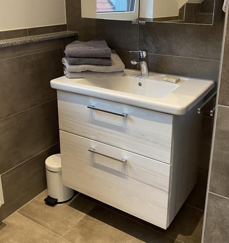 a bathroom with a white sink and a toilet at Ferienwohnung II in Schnelldorf