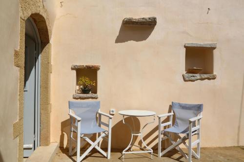 a table and chairs sitting next to a wall at Axion Studios in Aroniadika