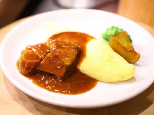 a plate of food with meat and bread on a table at Dormy Inn Kawasaki Natural Hot Spring in Kawasaki