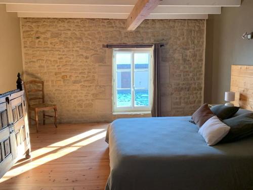 a bedroom with a large bed and a window at Gîte de groupe agritourisme 3 gîtes mitoyens 25 couchages Convivialité et intimité in Lingèvres