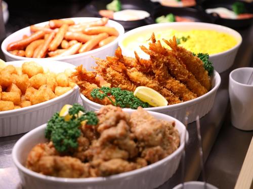 a group of bowls of food on a table at Dormy Inn Kawasaki Natural Hot Spring in Kawasaki