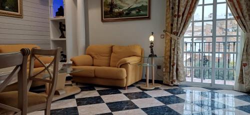 a living room with a chair and a table at piso en arenas de velez malaga in Málaga