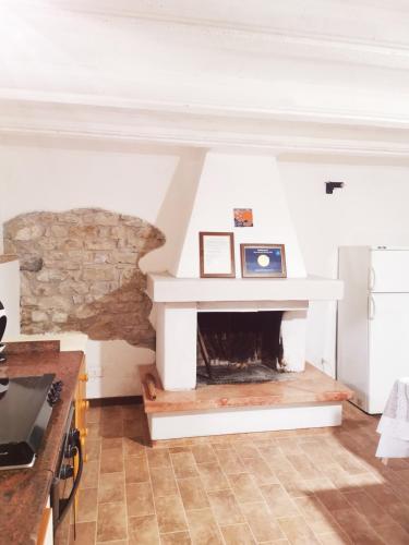 a fireplace in a living room with a stone wall at Villa La Pineta in Umbertide