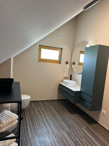 a bathroom with a sink and a mirror at Green Valley Apartments in Zavrč