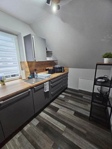 a kitchen with a sink and a counter at Ferienwohnung Muggelig in Kiel