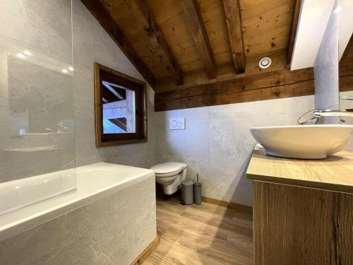 a bathroom with a sink and a tub and a toilet at Chalet Des Encombres - Pièces 314 in Saint-Martin-de-Belleville
