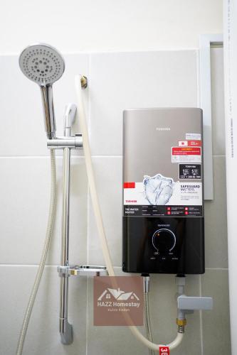 a water heater and a fan in a bathroom at HAZZ Homestay Kulim in Kulim