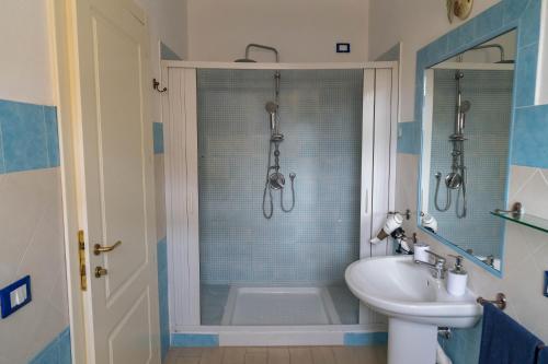 a bathroom with a shower and a toilet and a sink at Sabbia & mare in Porto Torres