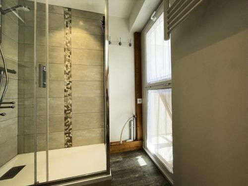 a shower with a glass door in a bathroom at Résidence Oisans - Studio pour 4 Personnes 514 in Les Menuires