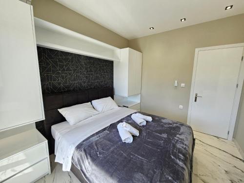 a bedroom with a bed with two towels on it at Evelina Luxury Suites in Corfu in Ýpsos