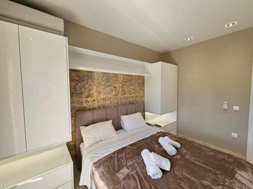 a bedroom with a bed with white towels on it at Evelina Luxury Suites in Corfu in Ýpsos