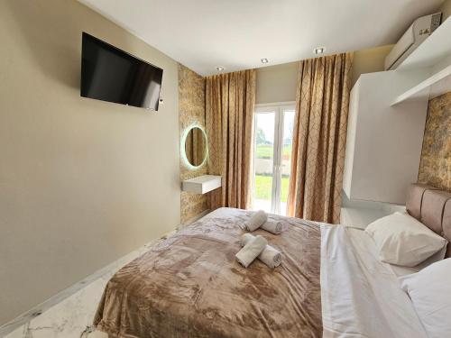 a bedroom with a bed with a teddy bear on it at Evelina Luxury Suites in Corfu in Ýpsos