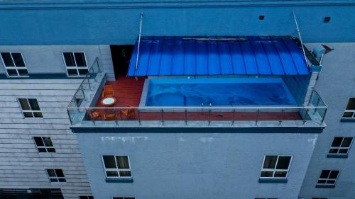 a building with a swimming pool on a balcony at LIMEWOOD HOTEL in Port Harcourt