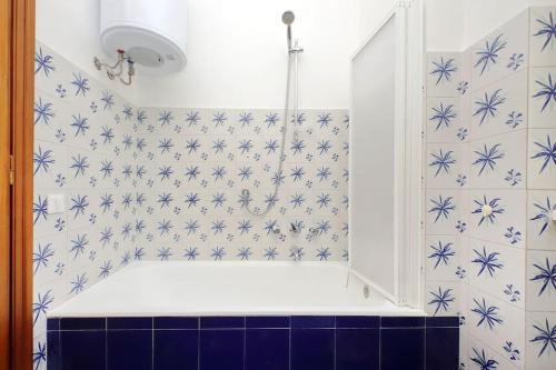 a bathroom with a shower with blue flowers on the wall at Virgy Green House in Rome